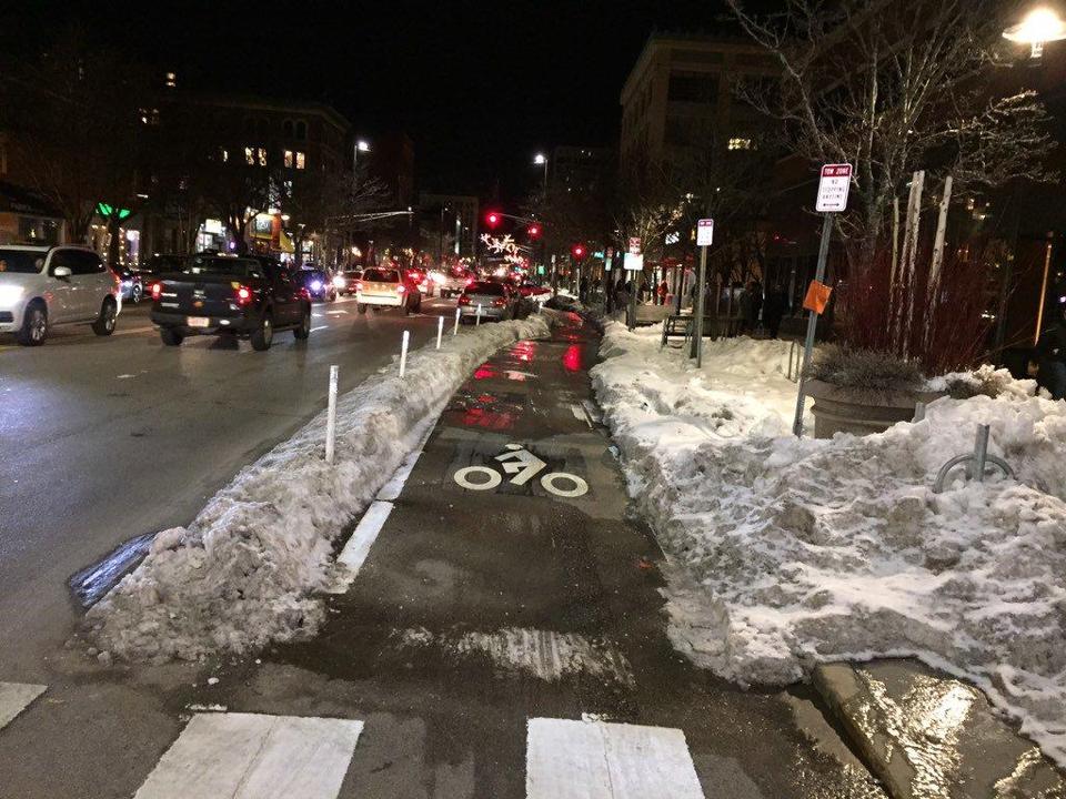 Snowmelt drains across "protected" bike lane on Massachusetts Avenue in Cambridge